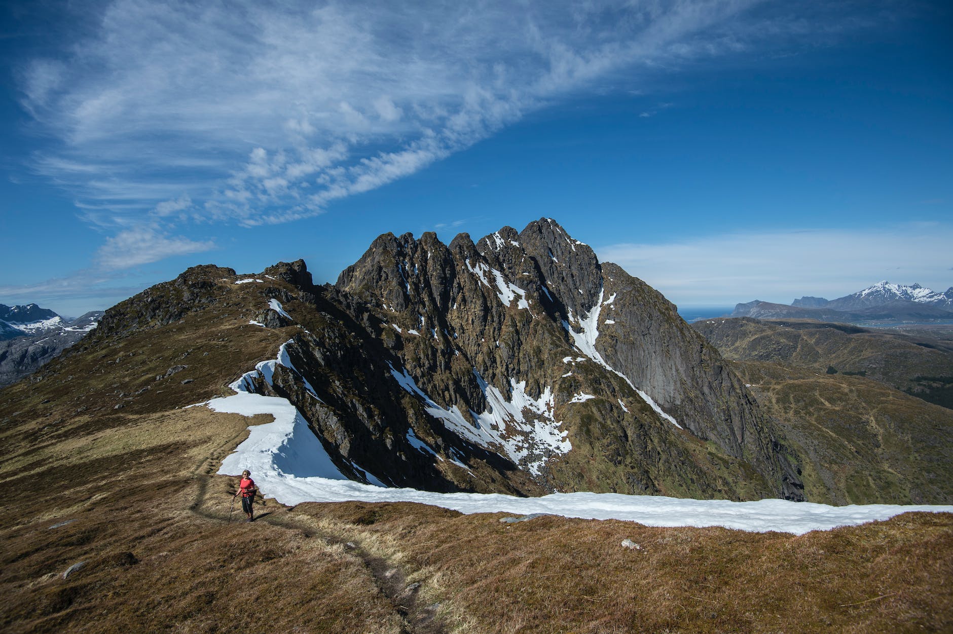 woman holding a trekking pole at mountain peak