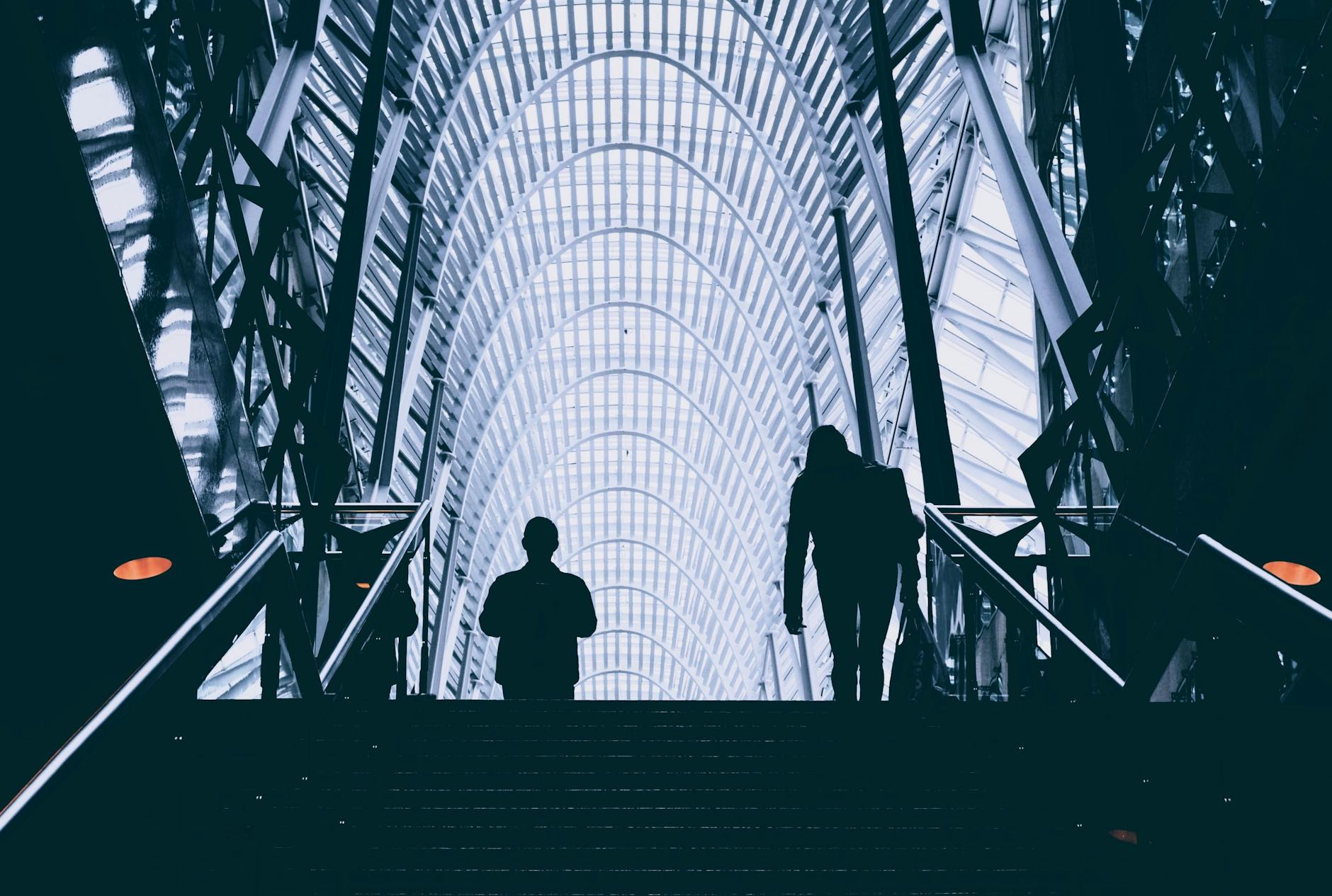 man and woman walking on stair