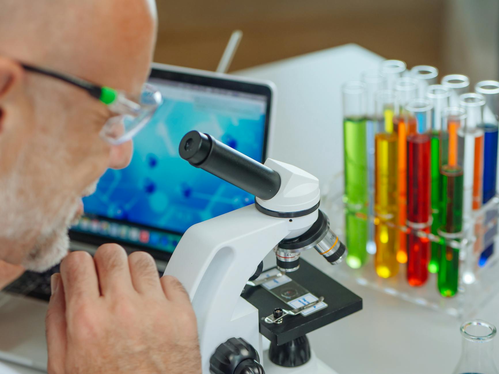 a man examining a microscope slide