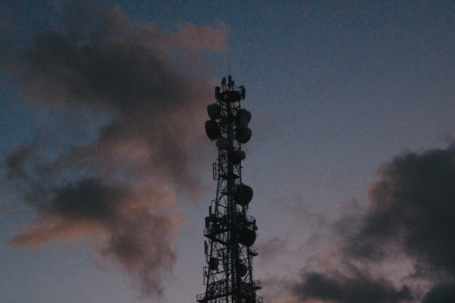 dramatic telecommunications tower at twilight