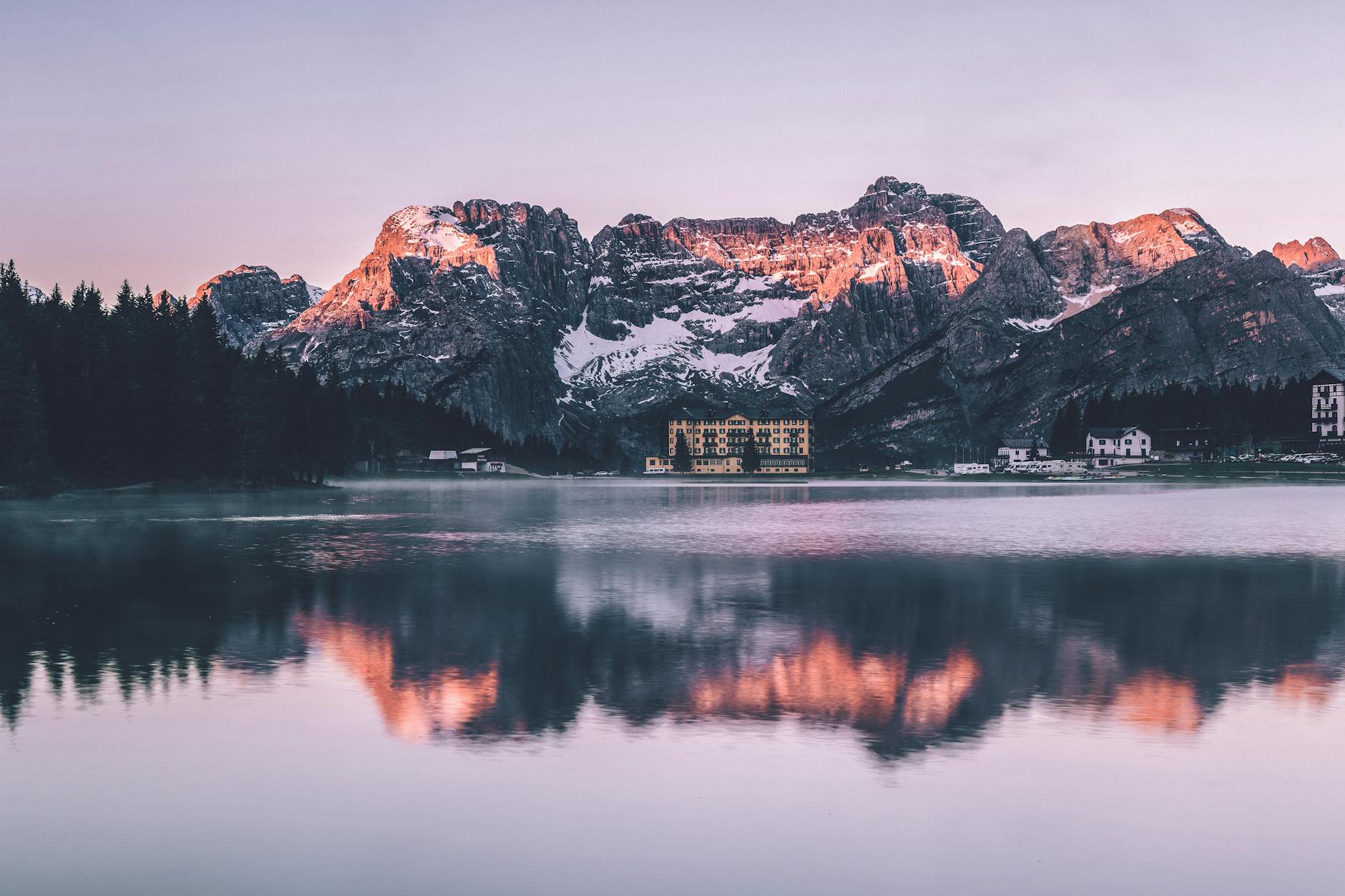 brown rocky mountain across body of water