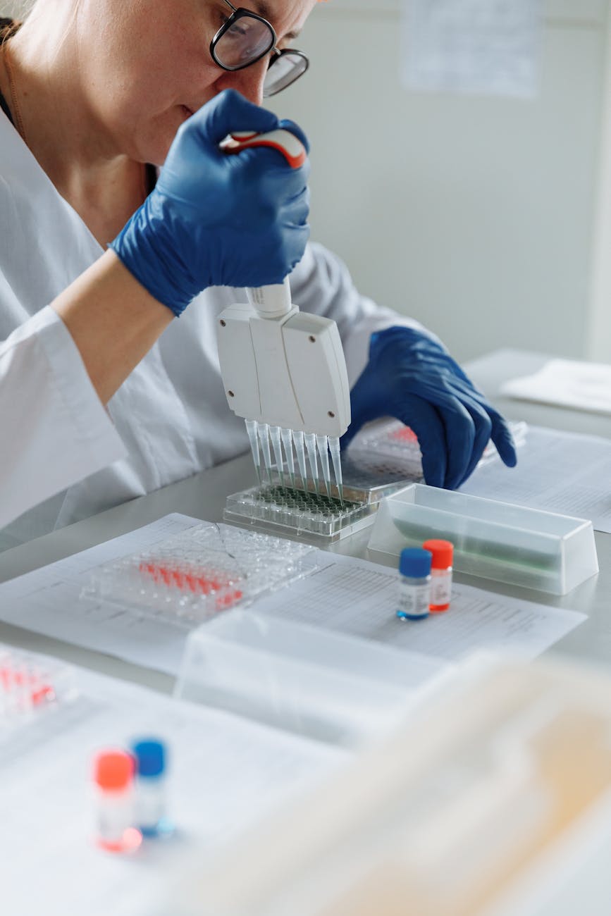 close up of a lab worker distributing medication into capsules