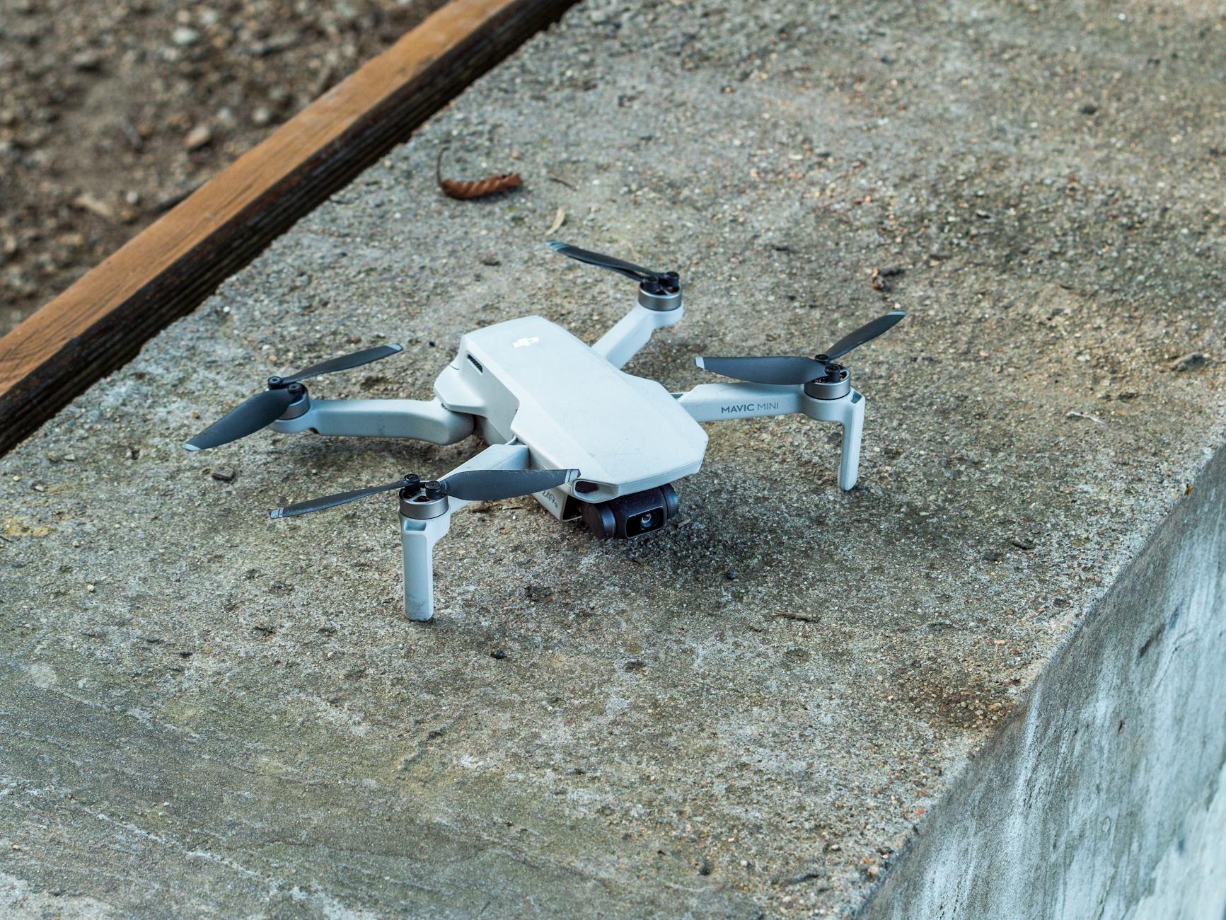 compact drone resting on concrete surface