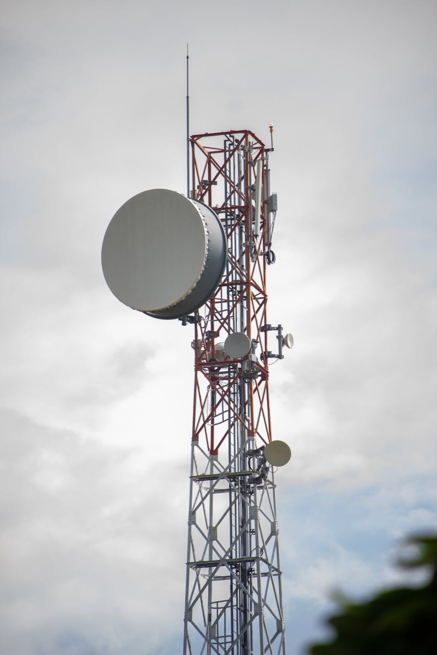 communication tower under white clouds