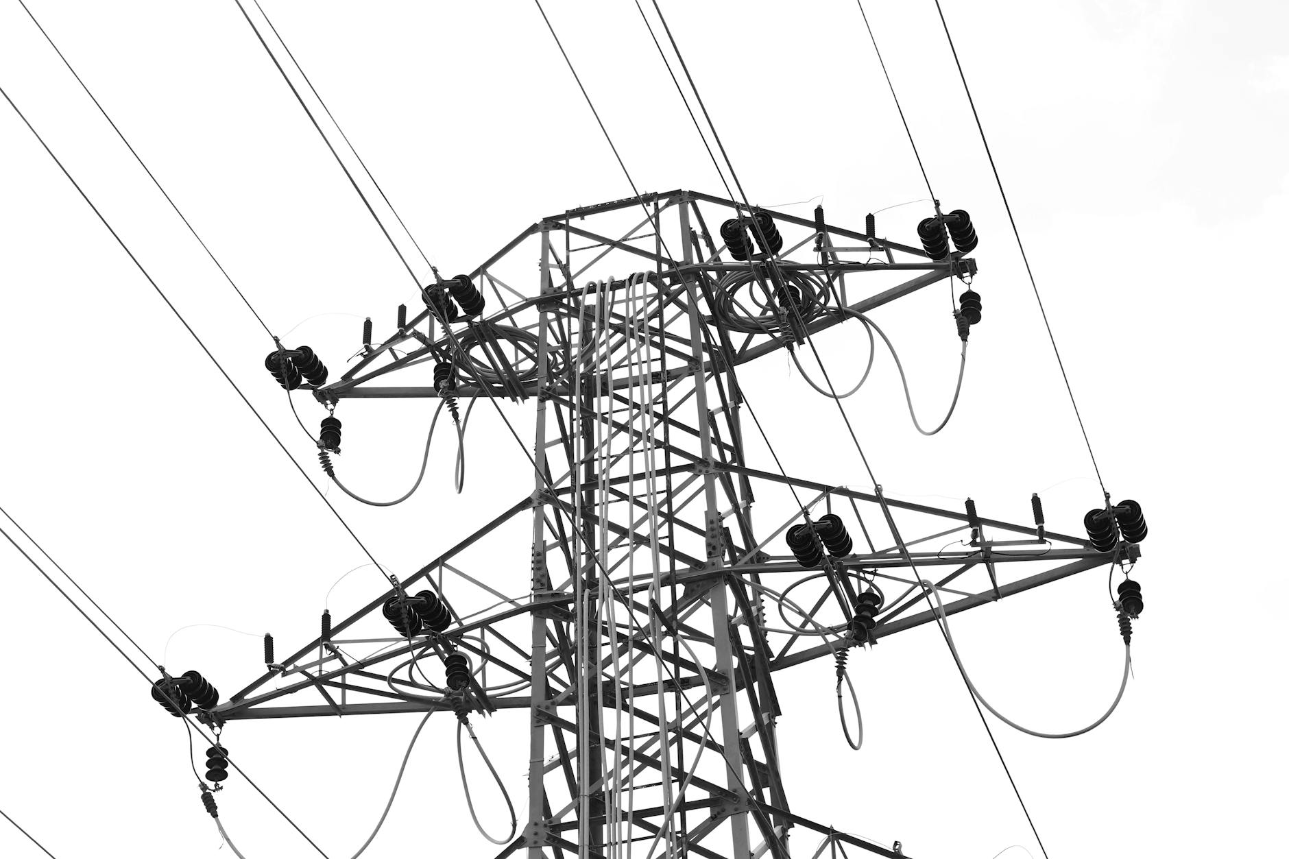high voltage power lines against clear sky
