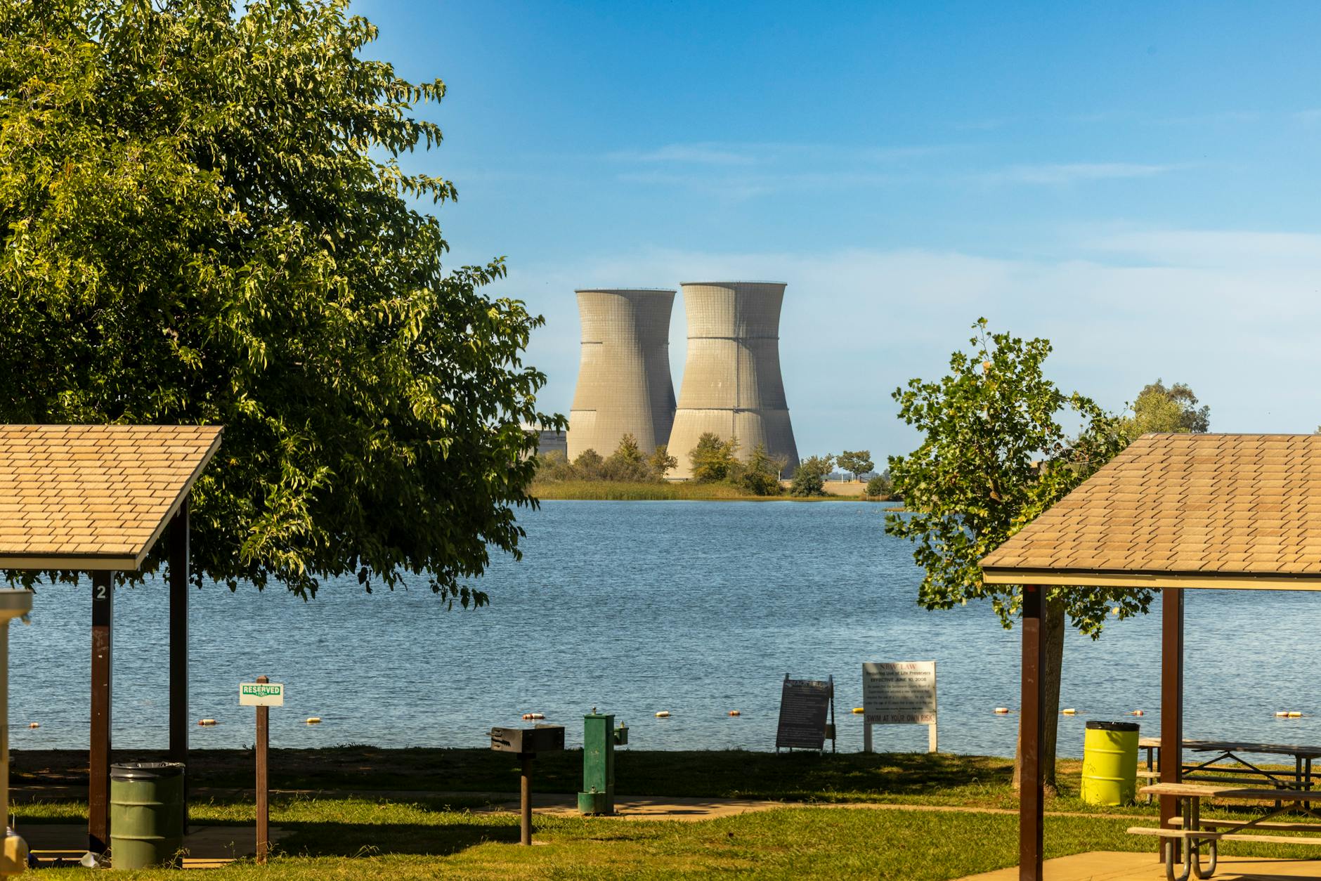 cooling towers by lakeside park on sunny day