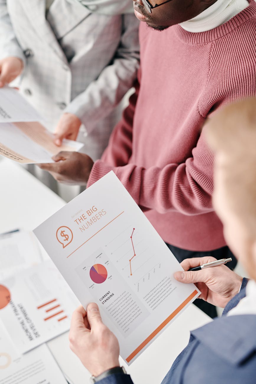 a person holding a paper with graphs and charts